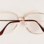 Glasses Frame - Stylish diverse glasses arranged in row lying down glasses on beige table
