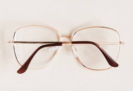 Glasses Frame - Stylish diverse glasses arranged in row lying down glasses on beige table