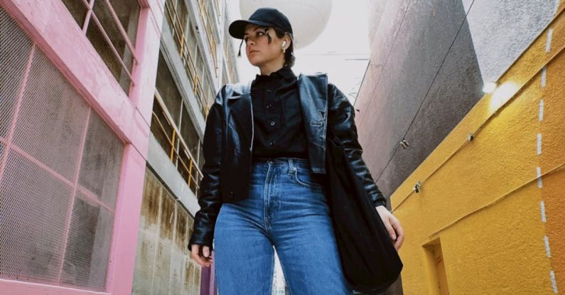 Selvedge Jeans - A woman in jeans and a hat standing in an alley