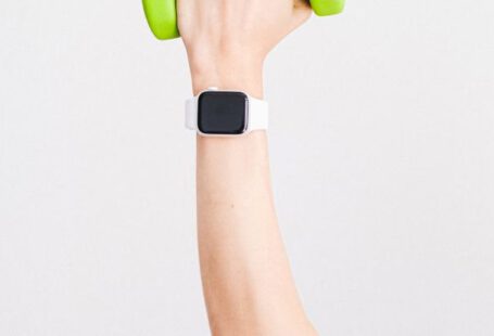 Digital Watch - Person Wearing White Apple Watch While Holding Green Dumbbell