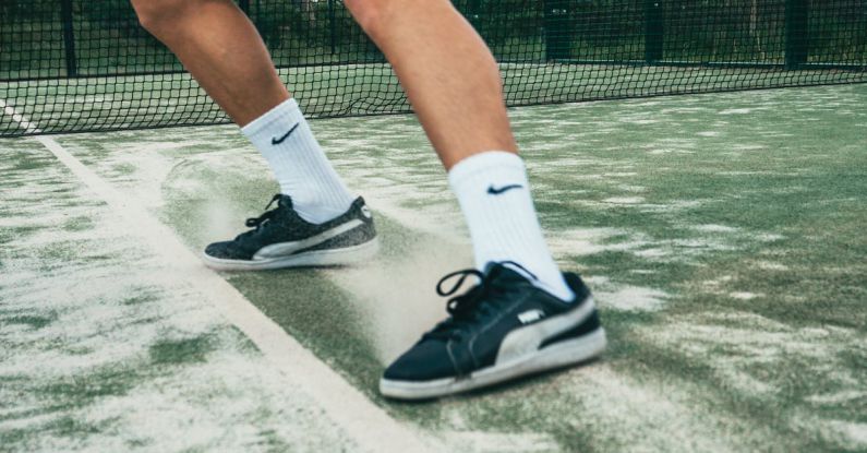 Athletic Shoes - Close-up Photo of Man Standing on Tennis Court