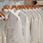 Wardrobe Basics - Clothes in Neutral Colors Hanging on the Racks in a Clothing Store