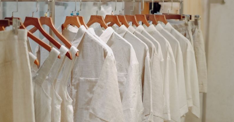 Wardrobe Basics - Clothes in Neutral Colors Hanging on the Racks in a Clothing Store