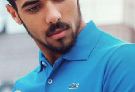 Polo Shirt - Man Wearing Blue Lacoste Polo Shirt and Silver-colored Analog Watch