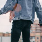 Denim Jacket - Photo of a Person Standing on Rooftop