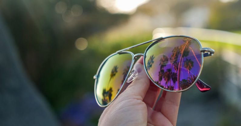 Polarized Lenses - Person Holding Silver Framed Sunglasses